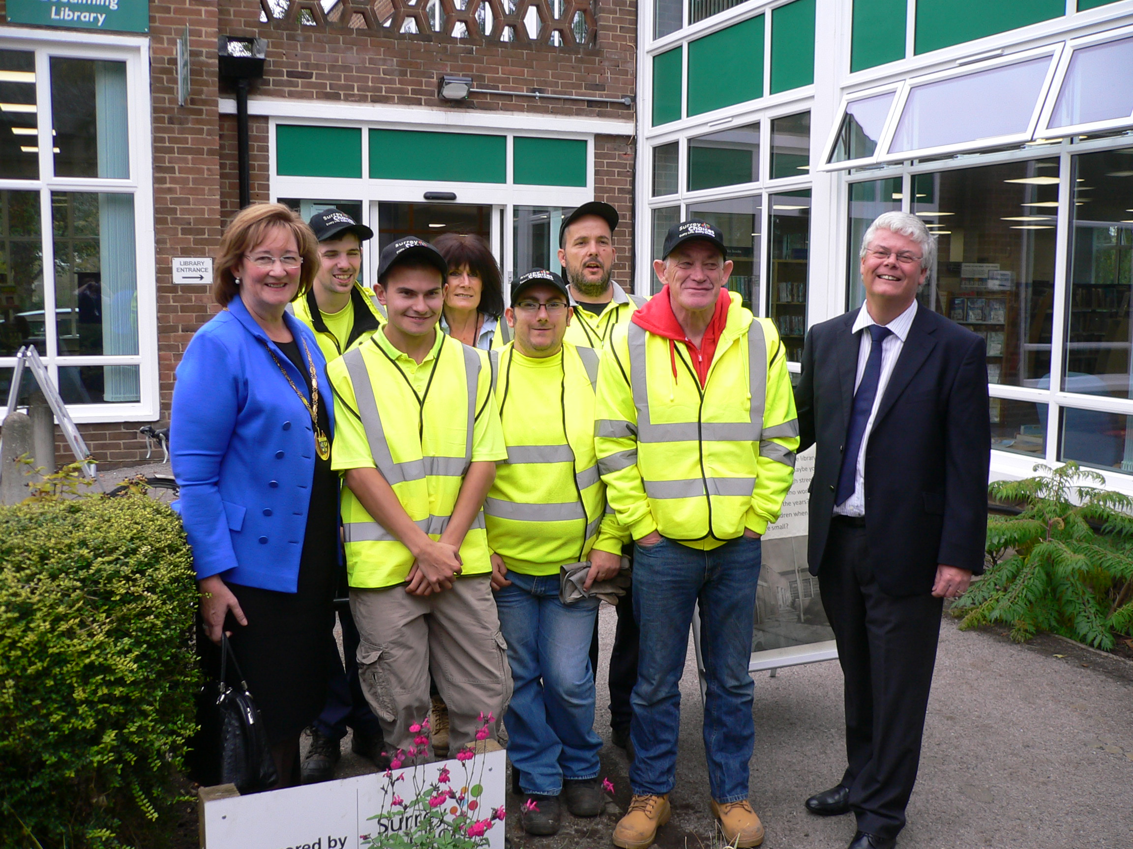The Growth Team pictured outside of Godalming Library after the gardening restoration project is completed with various planted boarders in the background