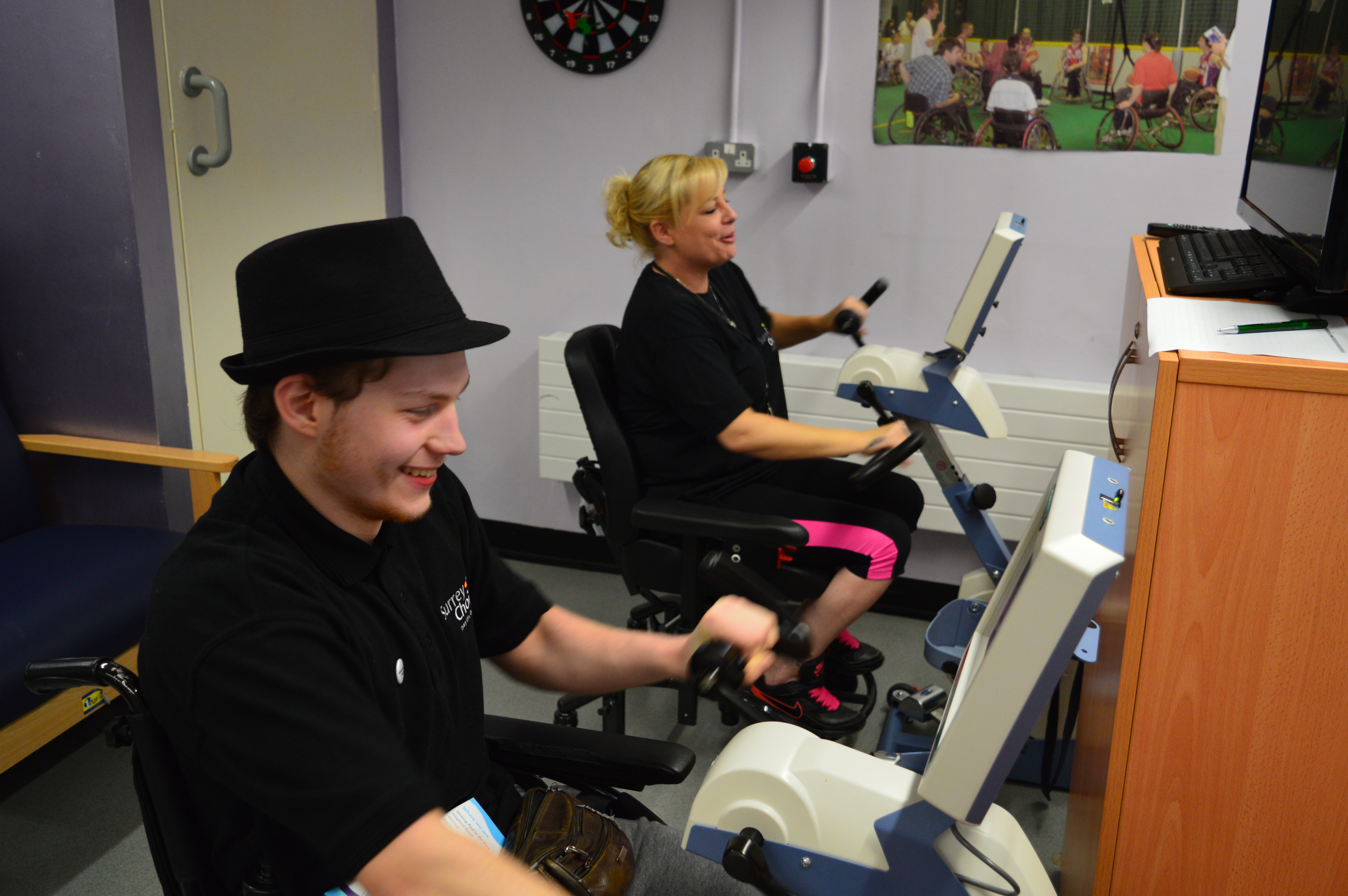 Anton working out on hand bicycle gym equipment with a colleague from Surrey Choices