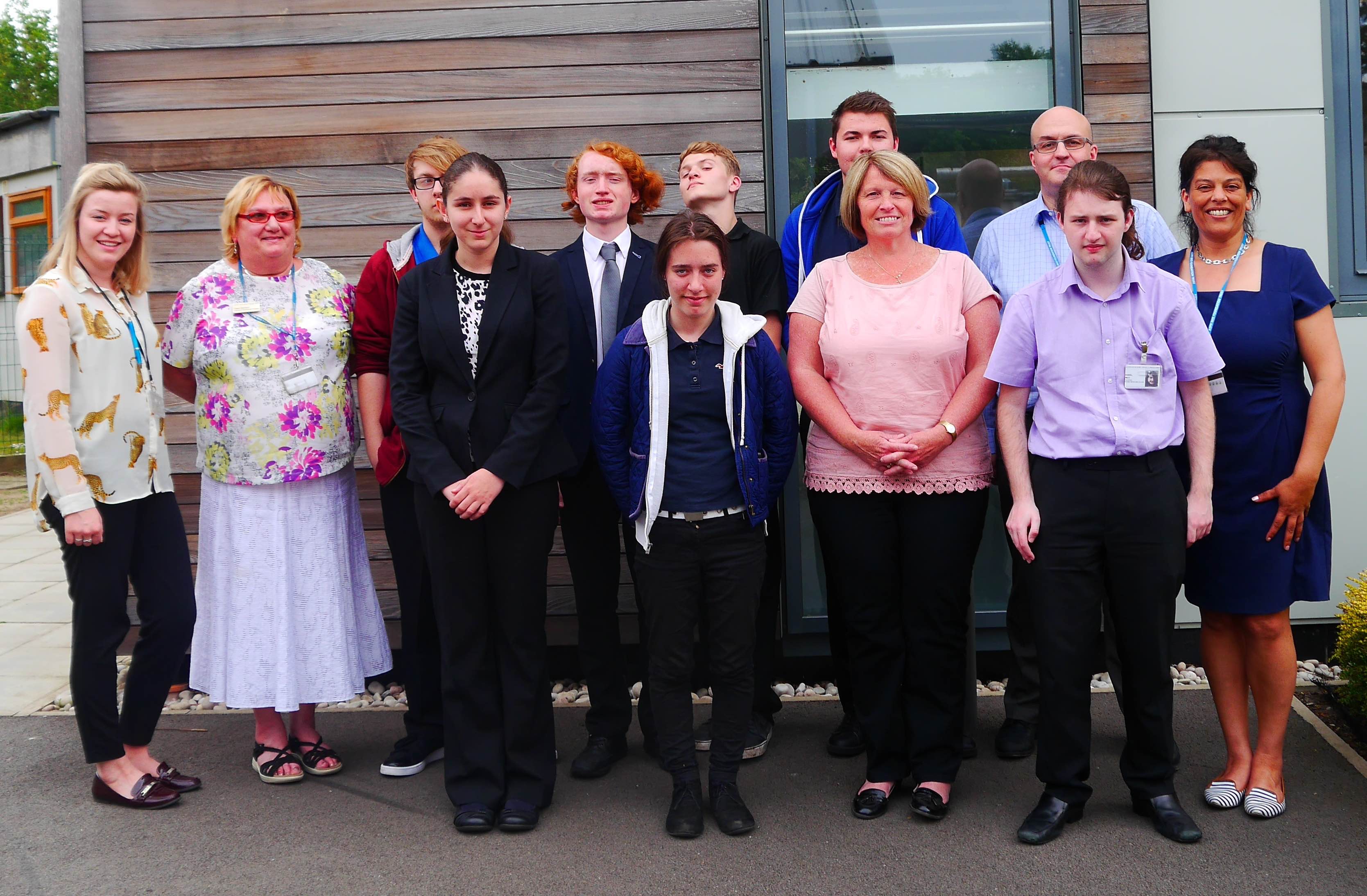 The successful students from Brooklands College with tutors and mentors all stood outside of a hospital building