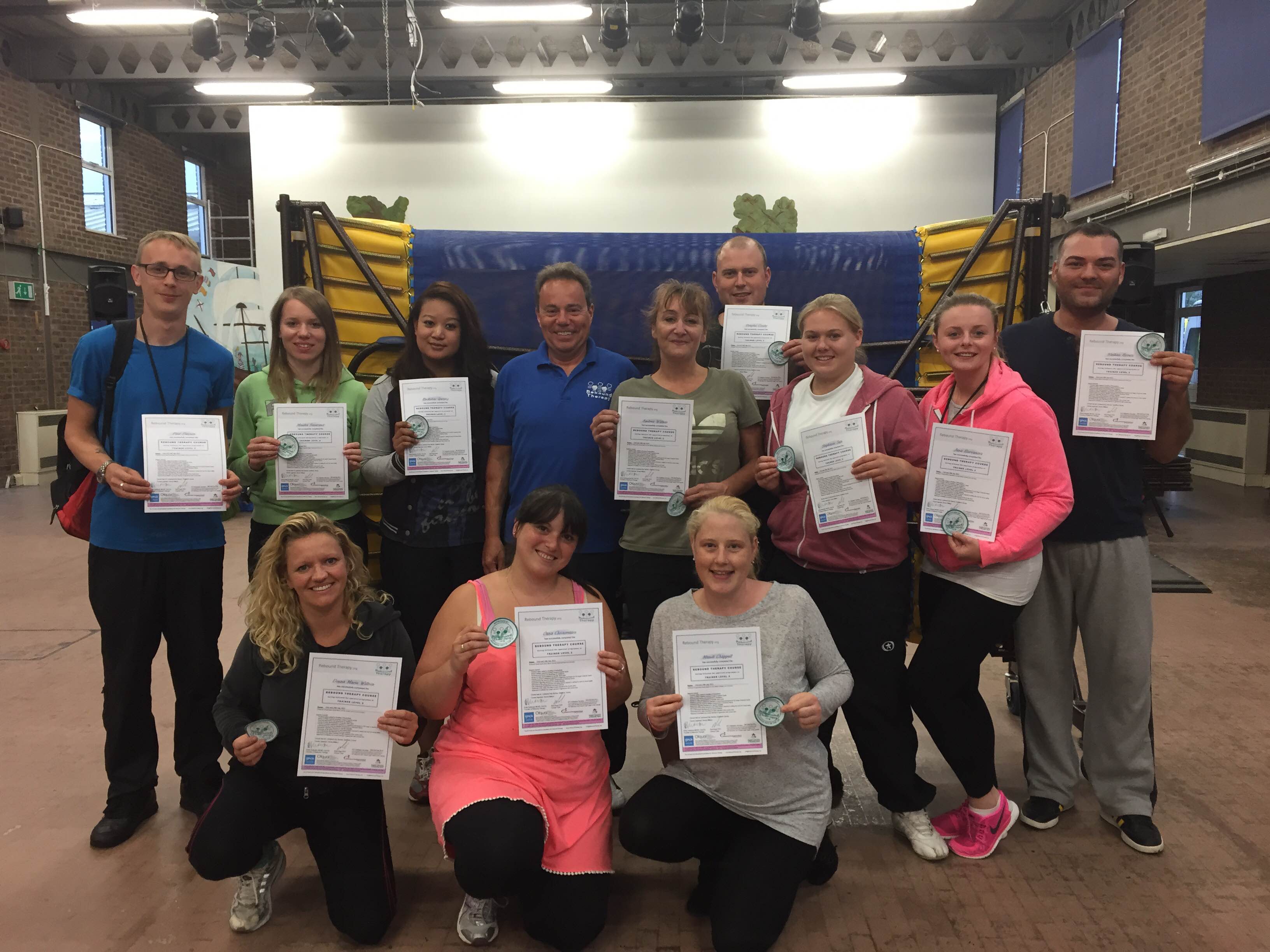 11 newly trained Rebound Therapists with their certificates and their trainer