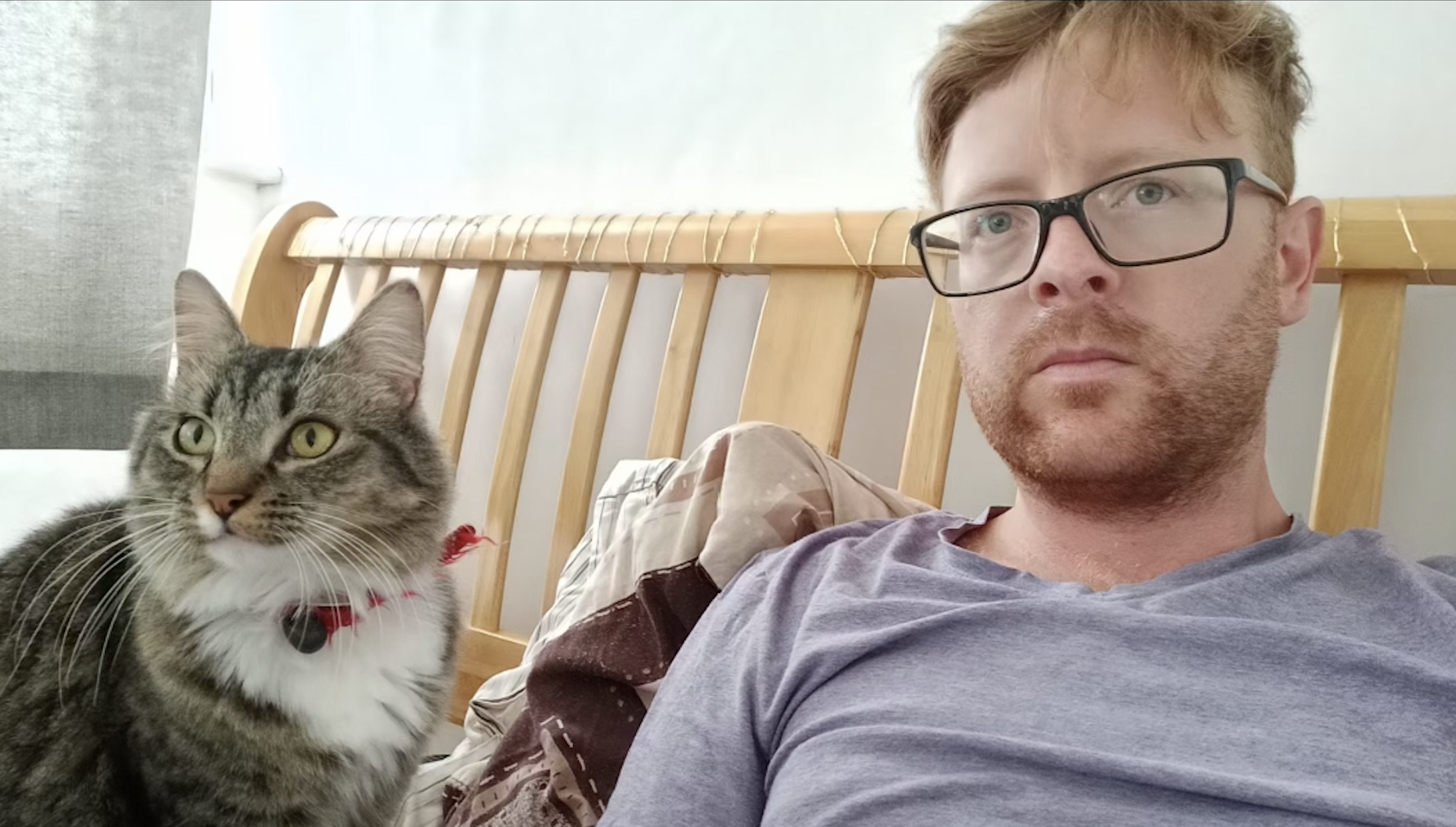 A picture of Adam with his cat taking a selfie
