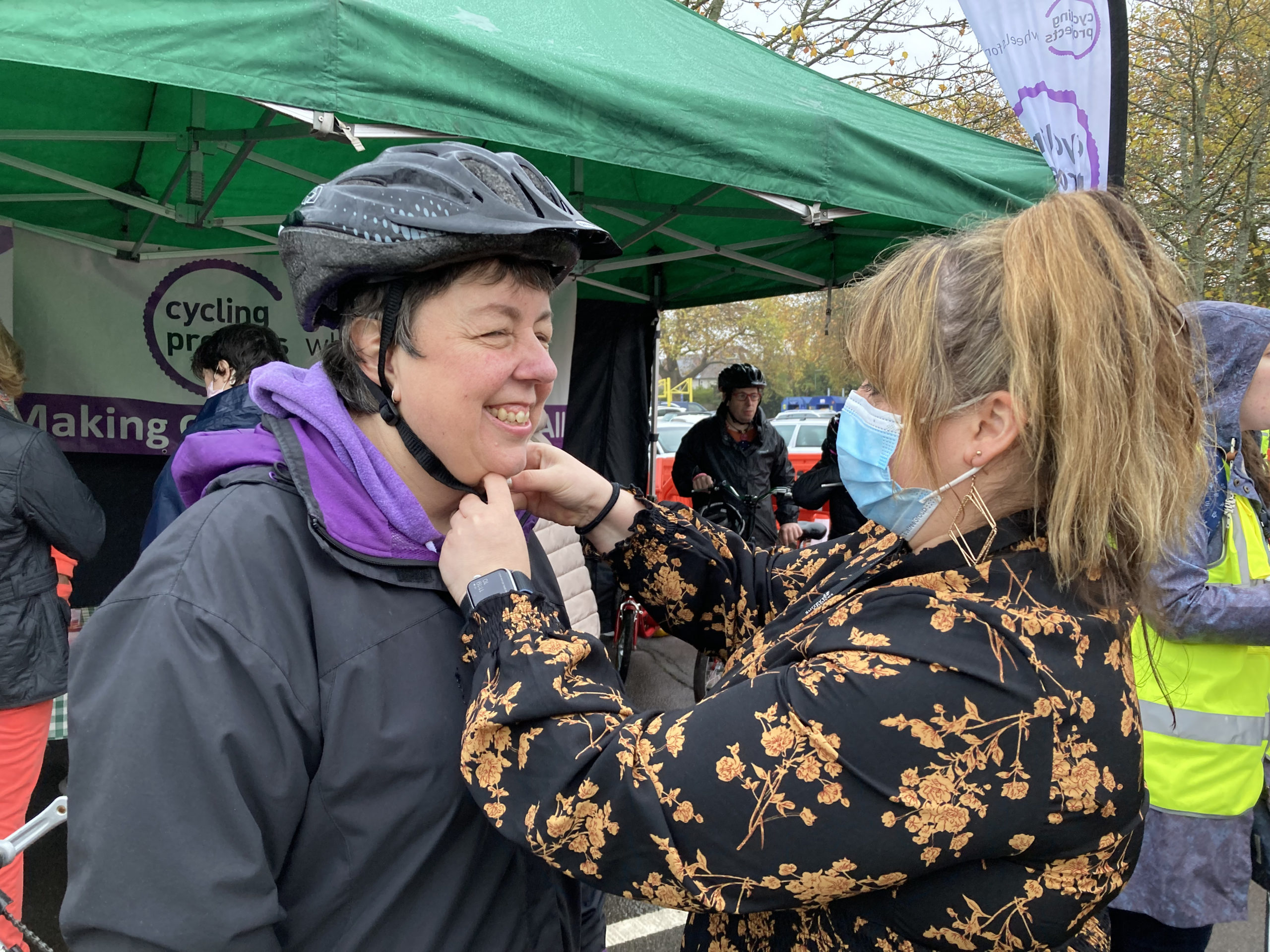 Community Support Worker helping someone with a bike helmet